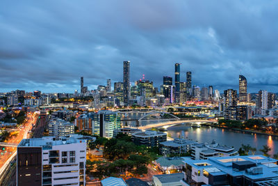 High angle view of illuminated cityscape against sky at night