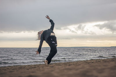 Full length of man jumping on beach