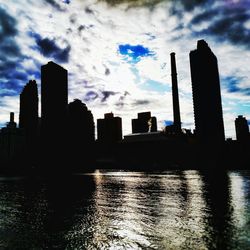 City skyline against cloudy sky