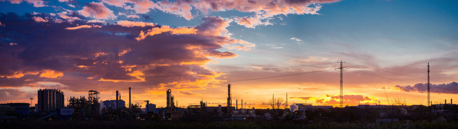 Panoramic view of silhouette buildings against sky during sunset