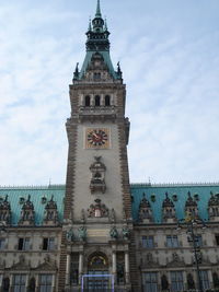 Low angle view of building against cloudy sky