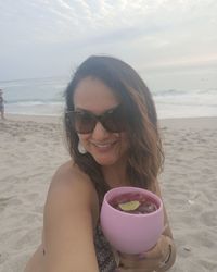 Portrait of smiling young woman on beach