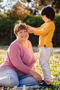 Side view of mother and daughter at park