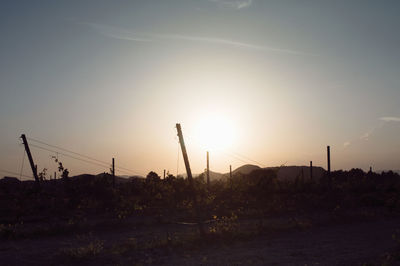 Wind turbines on landscape at sunset