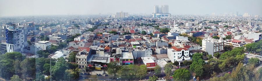 High angle view of city buildings against sky