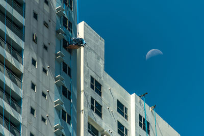 Low angle view of buildings against blue sky