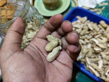 Close-up of hand holding roasted groundnut