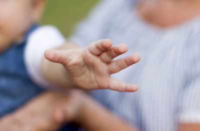 Cropped image of father holding hands