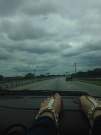 Low angle view of road against cloudy sky