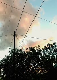 Low angle view of trees against sky during sunset