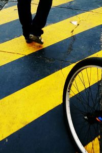 Low section of man with bicycle on street