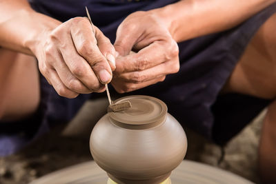 Close-up of a person at pottery wheel