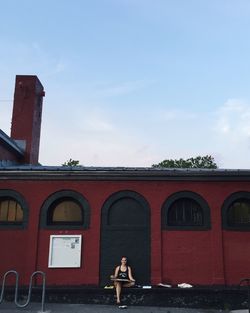 Woman standing in front of building