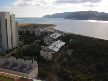 High angle view of sea and buildings against sky