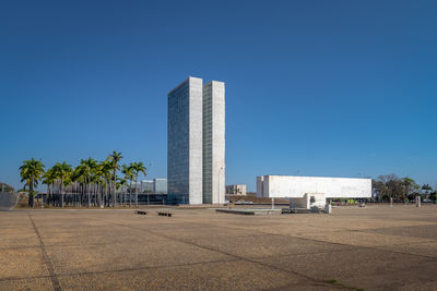 Scenic view of beach against clear blue sky