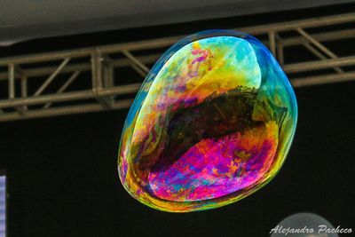 Low angle view of bubbles against rainbow