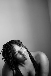 Close-up of woman with hair against white background