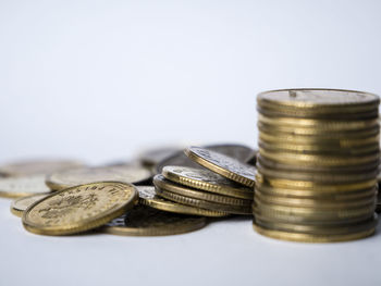 Close-up of coin stack against white background