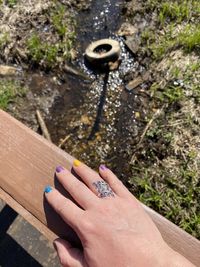 Close-up of hand holding ring