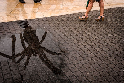 Low section of women walking on footpath