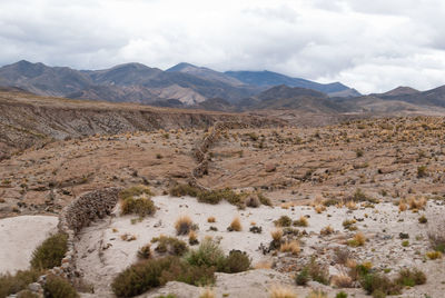 Scenic view of mountains against cloudy sky