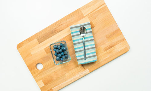 High angle view of objects on wood against white background