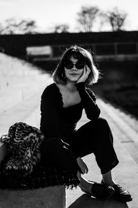 Portrait of young woman sitting outdoors