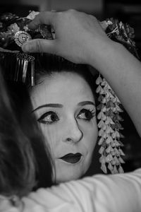 Cropped image of beautician hairstyling woman during event