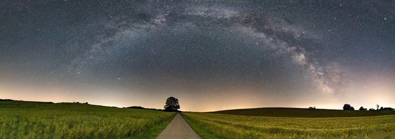 Scenic view of field against sky at night