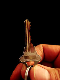 Close-up of man hand against black background