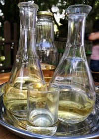 Close-up of wine in containers on table