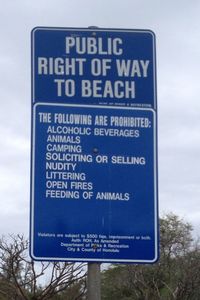 Low angle view of signboard against sky
