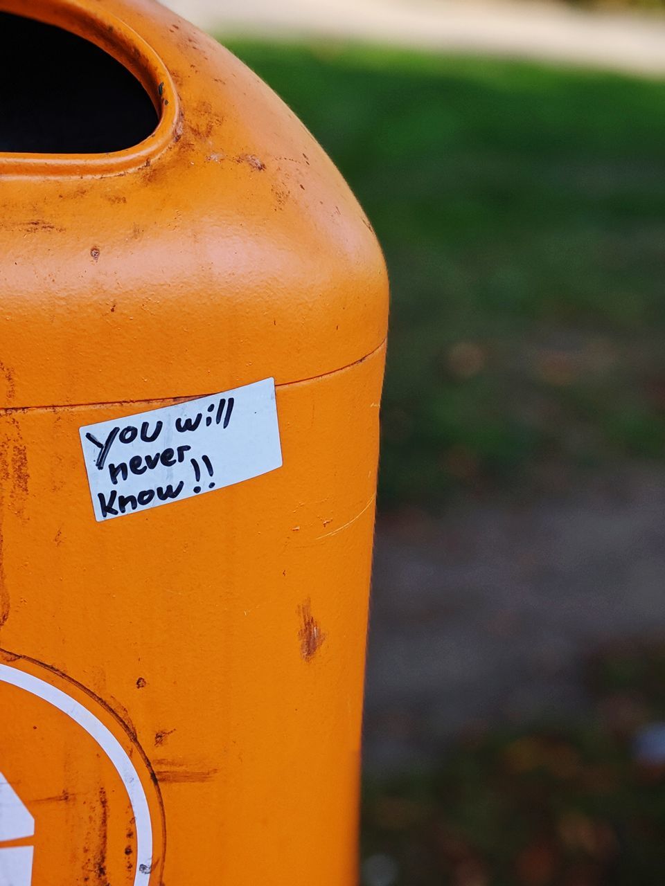 CLOSE-UP OF YELLOW TEXT ON METAL