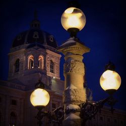 Low angle view of illuminated street light at night