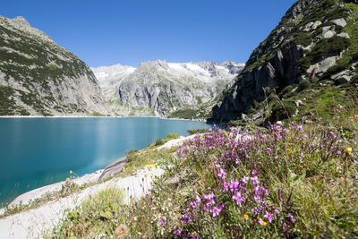 Scenic view of lake and mountains against sky