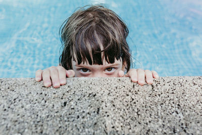 Portrait of cute boy in swimming pool