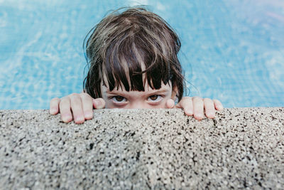 Portrait of girl relaxing in swimming pool