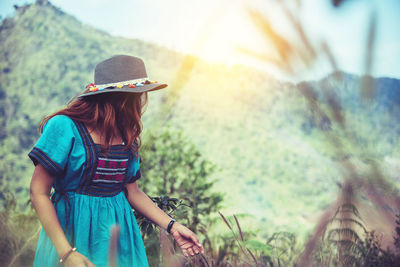 Full length of woman wearing hat standing on land