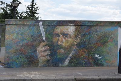 Graffiti on metal structure against sky