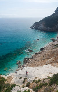High angle view of rocks by sea against sky