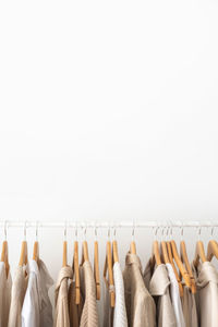 Clothespins hanging against white background