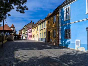 Street amidst buildings in city against sky