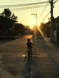 Man riding bicycle on road in city