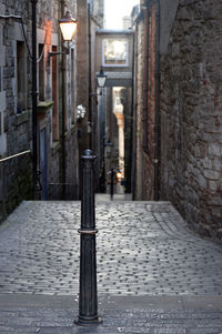 Narrow street amidst buildings in city