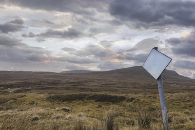 Windmill on field against sky