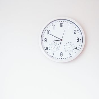 Close-up of wall clock over white background