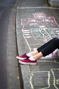 Low section of girl on sidewalk