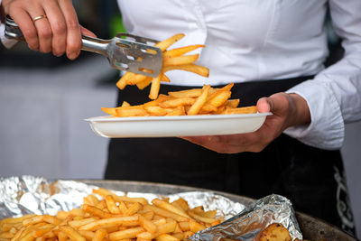 Close-up of hand holding french fries