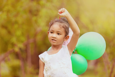 Portrait of cute girl with balloons