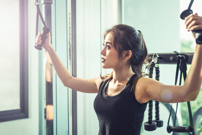 Young woman exercising in gym